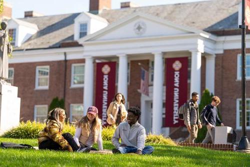 Three students enjoy the McSpedon quad on a sunny day.